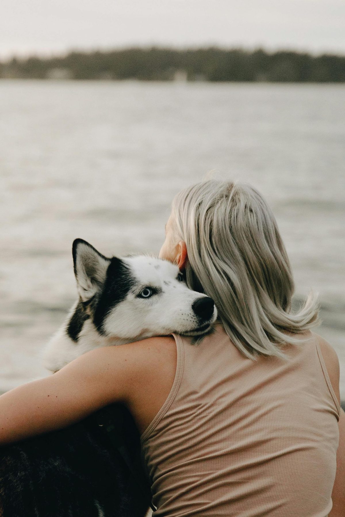 Woman hugging a dog after adoption